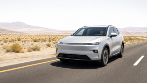 Photorealistic generic electric car driving on a sun-heated desert highway with visible heat shimmer