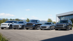 Bright realistic lineup of unbranded 2027-style SUVs, pickup truck and luxury sedan outside a dealership